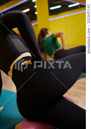 Flat feet correction exercise. Girl using spiked rubber roller. Flat feet correction exercise. Girl using spiked rubber roller. 102845142