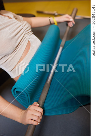 Close-up of a woman doing deadlift exercise alone at the gym. Close-up of a woman doing deadlift exercise alone at the gym. 102845145
