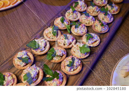 Banquet table with snacks, food on plates, festive table, corporate food 102845180