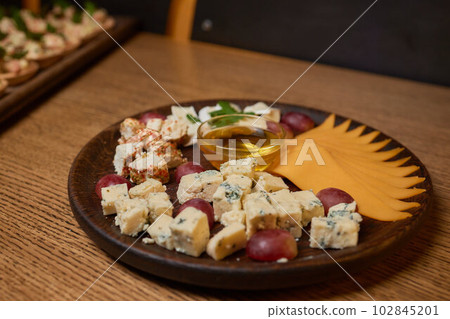 Banquet table with snacks, food on plates, festive table, corporate food 102845201