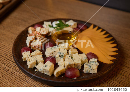 Banquet table with snacks, food on plates, festive table, corporate food Banquet table with snacks, food on plates, festive table, corporate food 102845660