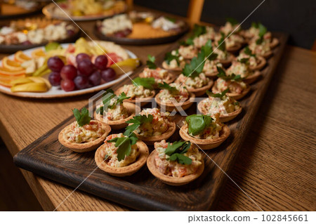 Banquet table with snacks, food on plates, festive table, corporate food 102845661