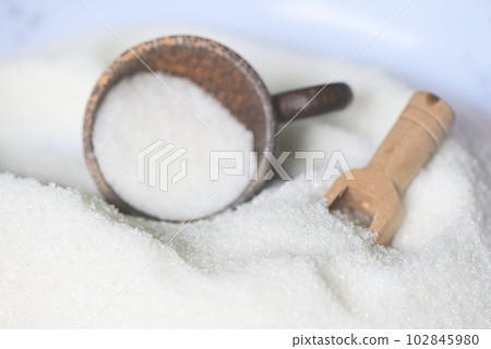 Sugar background, on wooden scoop , white sugar for food and sweets dessert candy heap of sweet sugar crystalline granulated 102845980