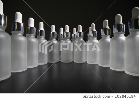 Large number of empty bottles with pipettes stand in circle Large number of empty bottles with pipettes stand in circle 102846194