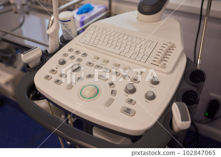 ultrasound machine doctor's hand usg investigation. ultrasound machine doctor's hand usg investigation. 102847065