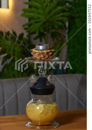 Stylish hookah with the aroma pineapple for relax.Pineapple shisha.Hookah lounge. Stylish hookah with the aroma pineapple for relax.Pineapple shisha.Hookah lounge. 102847552