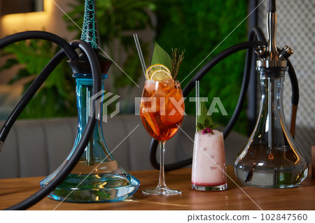 Wood hookah on table in hookah lounge. Wood hookah on table in hookah lounge. 102847560