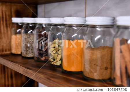 Spices in small jars on the spice shelf Spices in small jars on the spice shelf 102847798