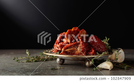 Sun-dried tomatoes in olive oil. 102847909