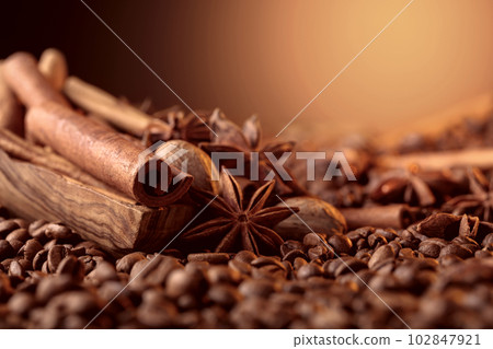Roasted coffee beans with cinnamon sticks, anise, and nutmeg. Roasted coffee beans with cinnamon sticks, anise, and nutmeg. 102847921