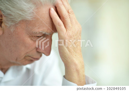 portrait of sad thinking senior man posing at home 102849105