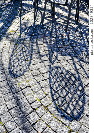 Terrace with shadows of garden chairs Terrace with shadows of garden chairs 102849334