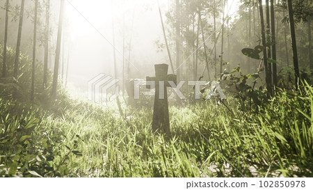 rustic stone cross amidst lush foliage rustic stone cross amidst lush foliage 102850978