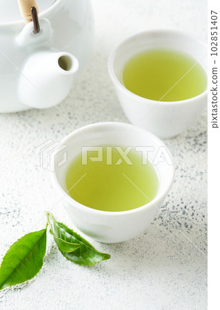 Green tea brewed in a teapot Green tea brewed in a teapot 102851407