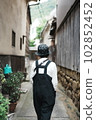 A woman strolling with the old streets of Tomonoura 102852452