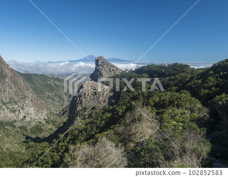 Scenic view from the Mirador del Bailadero with volcanic rock formations Los Roques and island Tenerife and Volcano Pico de Teide. Garajonay National Park on La Gomera, Canary Islands, Spain, Europe. 102852583