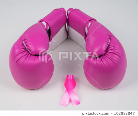 Pink boxing gloves and a pink silk ribbon on a white background. Breast cancer concept.  102852847