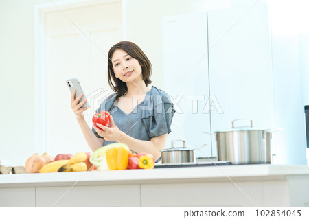 Young woman looking at a cooking recipe Young woman looking at a cooking recipe 102854045