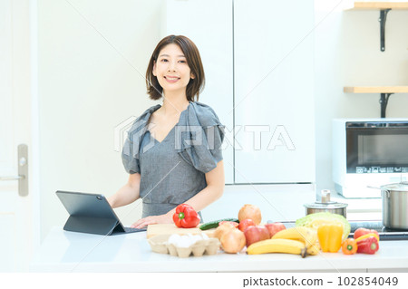 Young woman looking at a cooking recipe 102854049