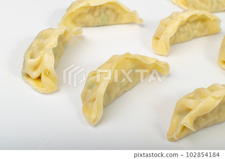 Gyoza Chinese Dumplings on WHite, Vegetable Jiaozi, Chicken Momo Pile, Asian Gyoza Group 102854184