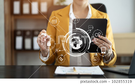 Person typing laptop computer and tablet with SDK icon on virtual screen. SDK Software development kit programming language technology concept in office. 102855319