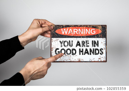 You are in good hands. Warning sign on a white background You are in good hands. Warning sign on a white background 102855359