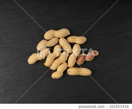 Peanuts on Black, Roasted Arachis Nuts Pile, Open Pea Nut, Whole Groundnut with Shell, Macro Peanut 102855416