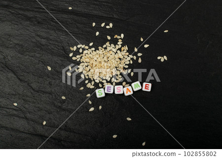 Sesame Seeds, White Sesamum Grains, Healthy Diet Garnish, Sesame Seeds on Black Background Sesame Seeds, White Sesamum Grains, Healthy Diet Garnish, Sesame Seeds on Black Background 102855802