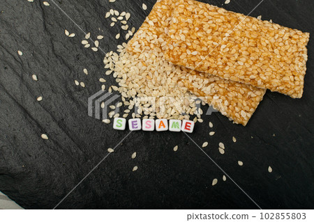 Sesame Snack, Honey Seed Cracker, Sesame Candy Bar on Black Background Sesame Snack, Honey Seed Cracker, Sesame Candy Bar on Black Background 102855803