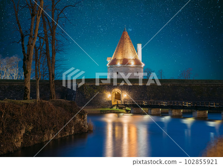 Kuressaare, Saaremaa Island, Estonia. Episcopal Castle In Evening Blue Hour Night. Traditional Medieval Architecture, Famous Attraction Landmark. Old Tower. Amazing Bold Bright Blue Starry Sky Kuressaare, Saaremaa Island, Estonia. Episcopal Castle In Evening Blue Hour Night. Traditional Medieval Architecture, Famous Attraction Landmark. Old Tower. Amazing Bold Bright Blue Starry Sky 102855921