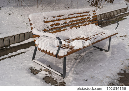 Wooden Bench in Snow, Frozen Winter Park, Outdoor City Architecture, Empty Plank Seat in Snowfall, Seasonal Travel Wooden Bench in Snow, Frozen Winter Park, Outdoor City Architecture, Empty Plank Seat in Snowfall, Seasonal Travel 102856166
