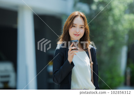 A woman walking outdoors 102856312