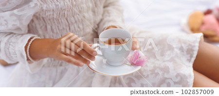 Summer Tea Picnic: Close-up of Female Hands With Cup o Tea 102857009