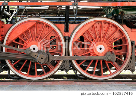 Big red wheels of a steam locomotive Big red wheels of a steam locomotive 102857416