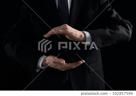 A pair of male hands holding the virtual Earth 102857594