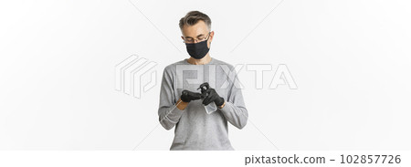Concept of coronavirus, lifestyle and quarantine. Image of middle-aged man in medical mask and gloves, applying hand sanitizer, preventing catching covid-19, white background Concept of coronavirus, lifestyle and quarantine. Image of middle-aged man in medical mask and gloves, applying hand sanitizer, preventing catching covid-19, white background 102857726