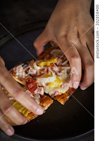 Sliced and served hawaiian mini pizza Sliced and served hawaiian mini pizza 102858400