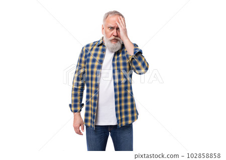 well-groomed 60s middle-aged gray-haired retired man with a mustache and beard is going through well-groomed 60s middle-aged gray-haired retired man with a mustache and beard is going through 102858858