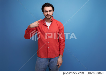 handsome brutal young brunette man in red shirt handsome brutal young brunette man in red shirt 102858860