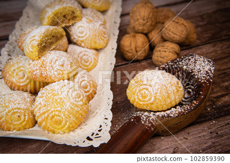 Traditional eid maamoul or mamoul cookies with dates, nuts, and jam, Arabic sweets for Aid al-Fitr Traditional eid maamoul or mamoul cookies with dates, nuts, and jam, Arabic sweets for Aid al-Fitr 102859390