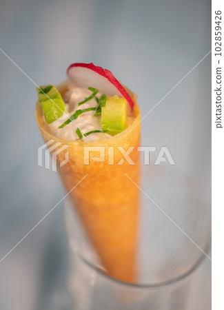 Brick cone with tuna sauce, mayonnaise, avocado and radish slice 102859426