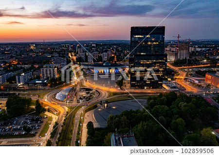 Aerial drone photo of Katowice centre with roundabout and modern office towers at evening. 102859506