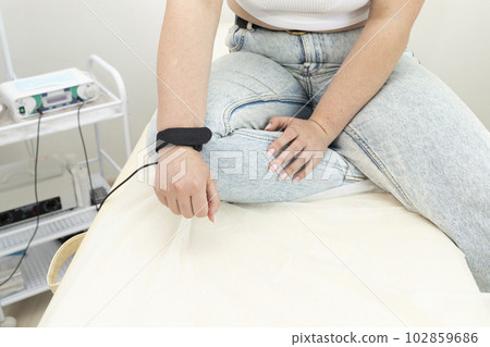 Cropped Female Client IS Ready To Hair Removal Procedure In Medical Room. Horizontal Plane. Hair Removal Treatment In Beauty Salon Concept. Cropped Female Client IS Ready To Hair Removal Procedure In Medical Room. Horizontal Plane. Hair Removal Treatment In Beauty Salon Concept. 102859686