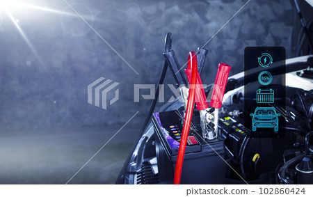Car battery charging in the auto repair garage with copy space, Batteries charging symbols 102860424