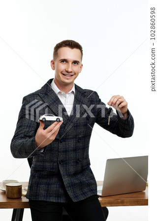 Successful caucasian cheerful man holding a toy car 102860598