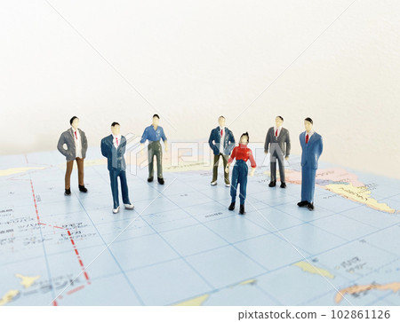 Seven people standing on the world map 102861126