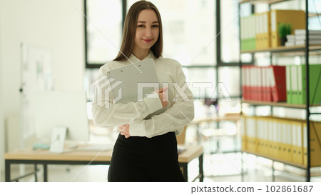 Woman manager with clipboard in hands in office portrait 102861687