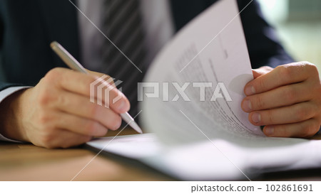 Businessman in suit signing and officially certificating important document closeup Businessman in suit signing and officially certificating important document closeup 102861691