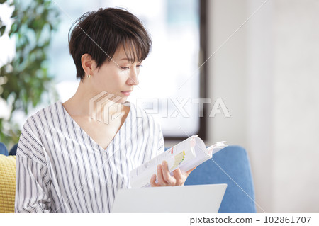 A woman studying qualifications A woman studying qualifications 102861707