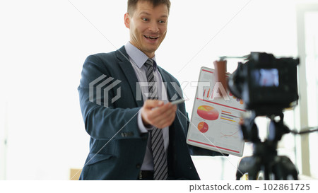 Freelancer business coach showing graphs to camera on video conference 102861725